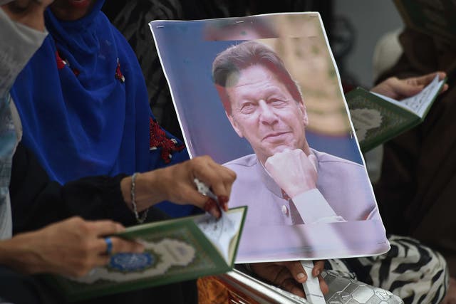 <p>Imran Khan’s supporters read from the Quran to mark anniversary of his  imprisonment, in Karachi, Pakistan, on 5 August 2024</p>