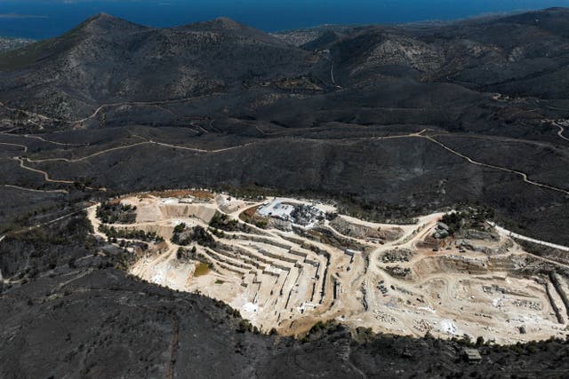 <p>Drone view shows a charred forest area around a marble quarry following a wildfire in Dionysos, near Athens, Greece</p>