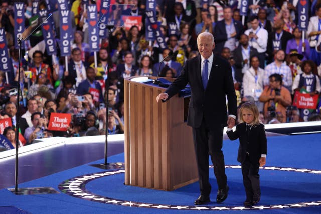 <p>Joe Biden walks with his grandchild at the Democratic National Convention on August 19. </p>