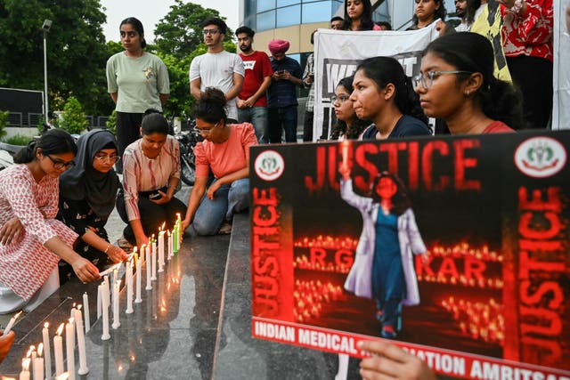 <p>Medical professionals light candles as they  pay tribute to a young doctor raped and murdered in Kolkata</p>