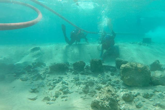 <p>Divers on a research team examine architectural remains at the underwater village of Habonim North, off Israel’s Carmel Coast</p>