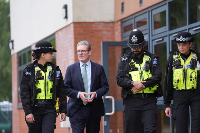 <p>Keir Starmer with officers of the West Midlands Police at Arden Academy in Solihull</p>