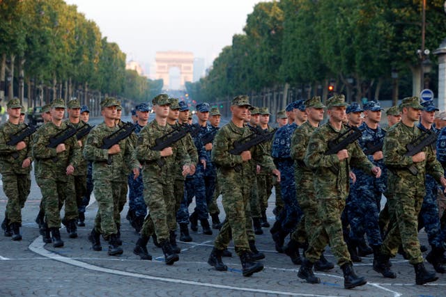 <p>FILE - Army Forces of Croatia walk during the rehearsal of the French Bastille Day parade at the Champs-Elysees avenue in Paris, Tuesday, July 9, 2013</p>