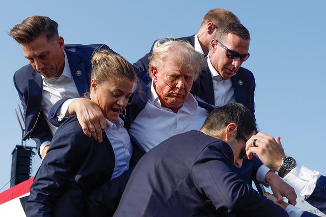 <p>Former President Donald Trump is rushed offstage by U.S. Secret Service agents after being grazed by a bullet during a rally on July 13, in Butler, Pennsylvania. Now, according to a report, the Secret Service wants to put bulletproof glass around Trump’s podium at future outdoor rallies. </p>