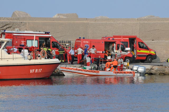 <p>Italian firefighters and scubadivers prepare to sail toward the area where the yacht sunk </p>