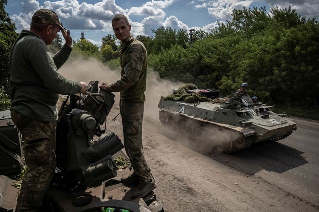 <p>Ukrainian service members ride an armoured personnel carrier in Sumy, near the Russian border</p>