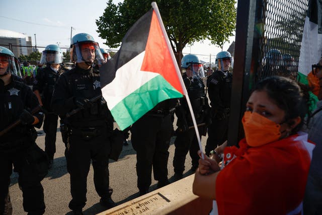 <p>Protesters break through security fence on first night of Democratic National Convention in Chicago on Monday </p>