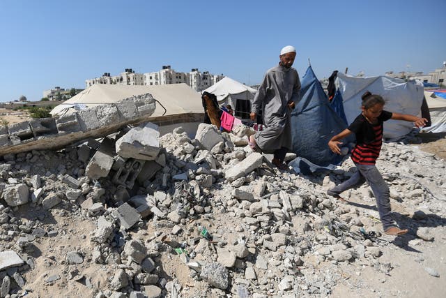 <p>Displaced Palestinians shelter in a cemetery in Khan Younis in southern Gaza</p>