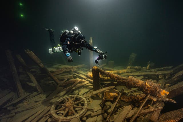 <p>A diver from the Polish Baltictech team inspects wreckage of a 19th century sailing ship that the team discovered</p>