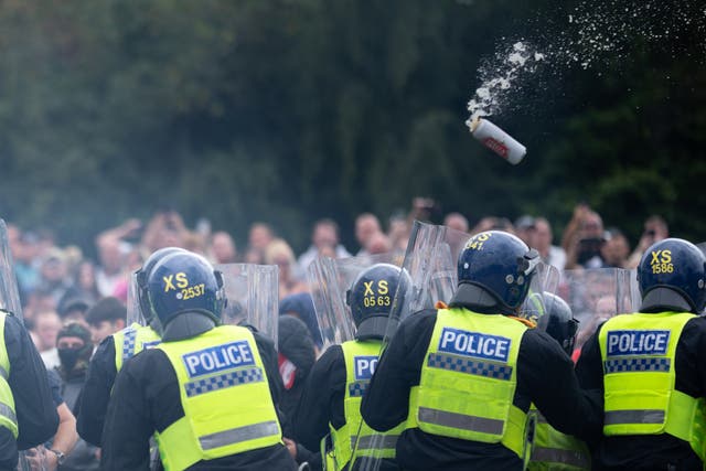 <p>Riot police officers push back anti-migration protesters outside the Holiday Inn Express in Rotherham </p>