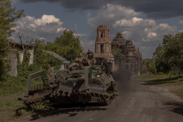 <p>Ukrainian servicemen operate an armoured military vehicle on a road near the border with Russia, in the Sumy region of Ukraine</p>