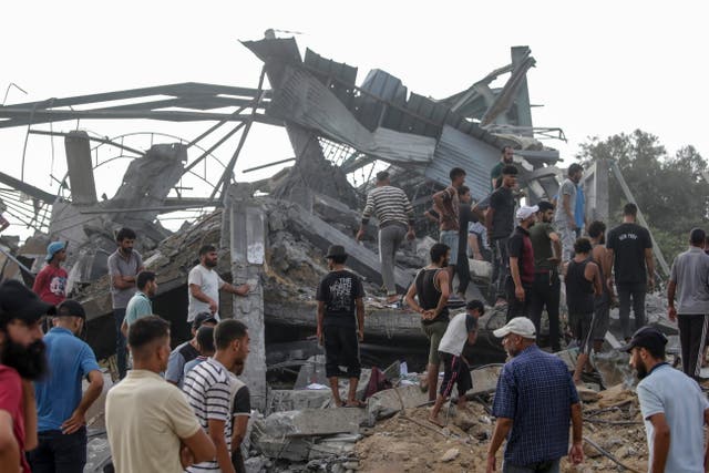 <p>Palestinians search for bodies and survivors among the rubble of the destroyed building after the airstrike </p>