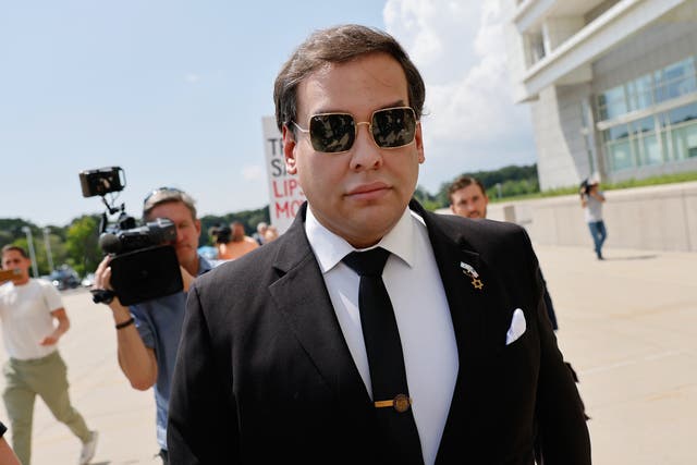 <p>George Santos walking into federal court in Central Islip, New York on Monday. He previously pleaded not guilty to the 23 criminal charges against him</p>