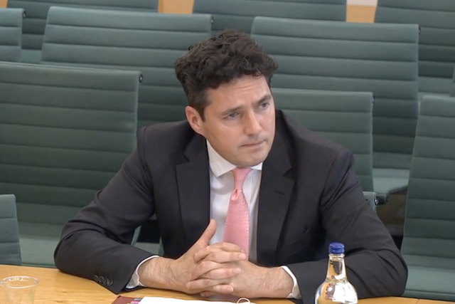 <p>Huw Merriman, the former rail minister, appearing at the transport select committee</p>