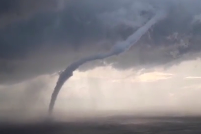 <p>A waterspout sweeps across the Mediterranean Sea near an Italian island</p>